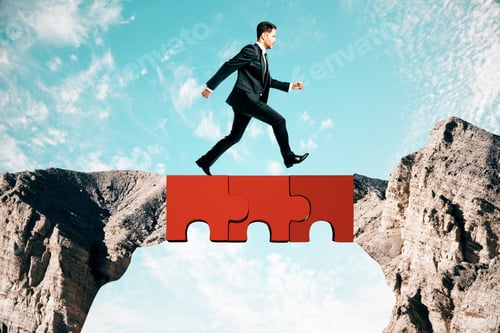 Preview: Young Businessman Crossing Abstract Jigsaw Bridge On Sky Background. Teamwork And Challenge Concept