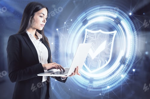 Preview: Attractive Young European Businesswoman With Laptop And Glowing Shield Hologram Standing In Blurry