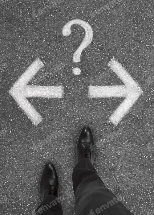Preview: Pair Of Feet Standing On Tarmac Road With Arrows And Question Mark