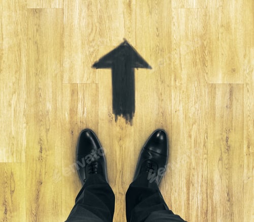 Preview: Top View Of Businessmen Feet On Wooden Floor With Drawn Arrow. Start Concept
