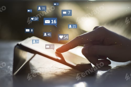 Preview: Close Up Of Hand Using Tablet Device At Desktop With Social Media Icons On Blurry Outdoor