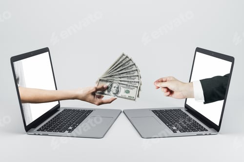 Preview: Hand Passes A Wad Of Dollars Through Laptops Screens On White Background. Financial Success And