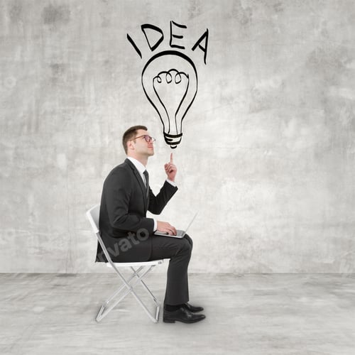 Preview: Businessman Sitting With Notebook And Pointing To Lamp