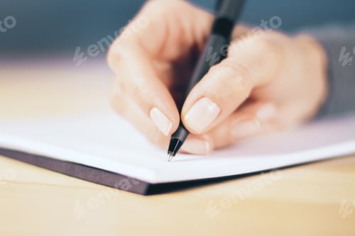 Preview: Girl Hand With Pen And Notebook On Wooden Table, Close Up