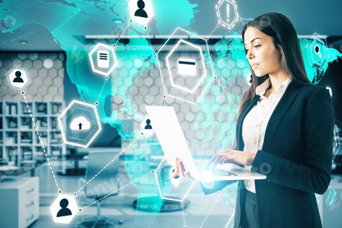 Preview: Businesswoman With Laptop Working With Global World Interface In Blurry Office. Cloud Computing And