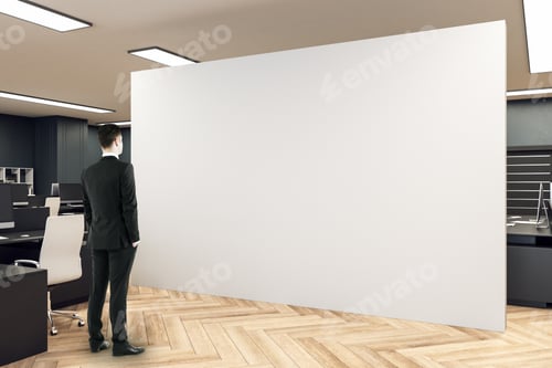 Preview: Businessman Looking On Blank Wall In Coworking Office Interior With Computers. Consulting Company