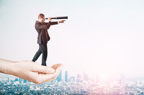 Preview: Vision And Future Concept. Hand Holding Businessman With Telescope On Sky Background With Copy Space