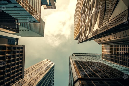 Preview: Bottom View Of Skyscrapers On Bright Blue Sky Background. Urban And District Concept