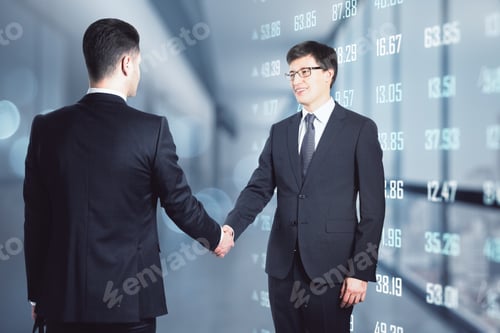 Preview: Agreement And Deal Concept With Businessmen Handshaking On Background With Market Quotes On Digital