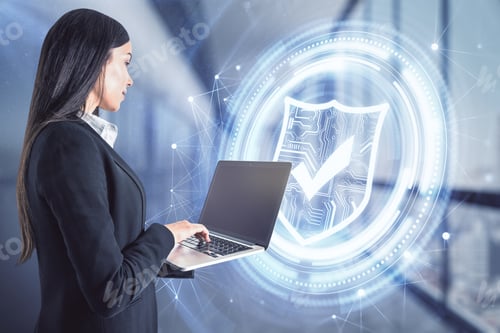 Preview: Portrait Of Attractive Young European Businesswoman With Laptop Standing In Blurry Office Interior