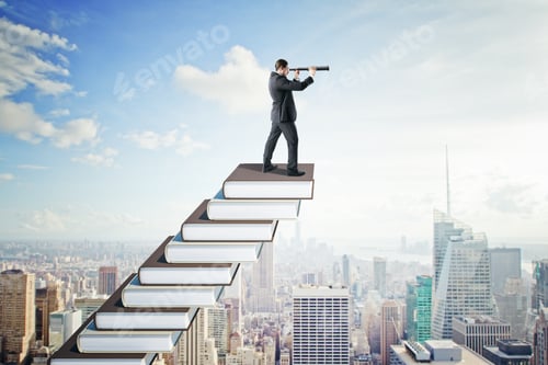 Preview: Side View Of Young Businessman With Telescope On Creative Book Ladder. New York City Skyline