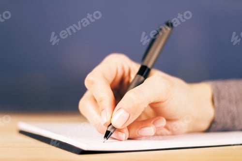 Preview: Girl Writes Notes In Diary On Wooden Table, Close Up