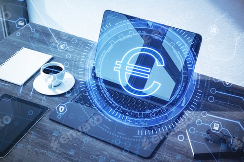 Preview: Close Up Of Laptop With Creative Glowing Euro Sign On Blurry Desktop Background With Coffee Cup And