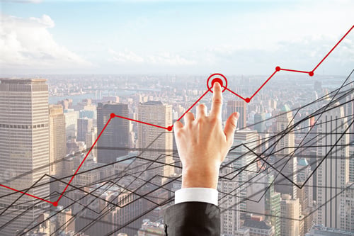 Preview: Hand Pointing At Abstract Business Charts On Bright City Background. Finance Concept