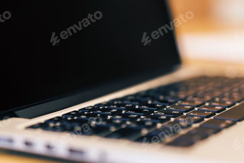 Preview: Side View Of Blank Laptop Computer Display On Wooden Desktop. Blurry Background. Technology
