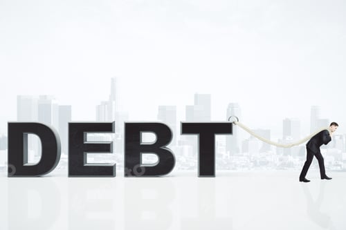 Preview: Debt Burden Concept With Businessman Pulls Debt Word On The Rope At City Backgroound