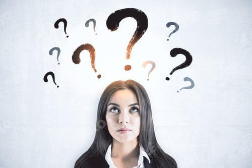 Preview: Thinking Businesswoman With Question Marks Standing On White Wall Background. Confusion And Doubt