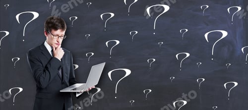 Preview: Thinking Concept With Pensive Businessman With Laptop On Chalkboard Background With Question Marks