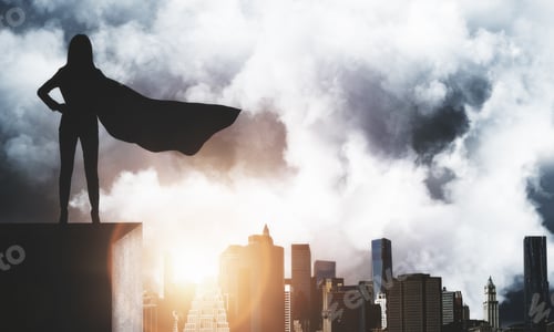 Preview: Backlit Superhero Businesswoman With Waving Cape Standing On Rooftop On City And Sky Background