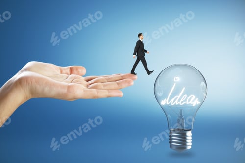 Preview: Hand Holding Businessman Walking Towards Idea Lamp On Blue Background. Innovation And Power Concept