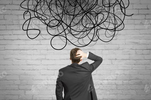 Preview: Back View Of Businessman Looking At Abstract Scribble On Brick Wall Background. Question, Think And