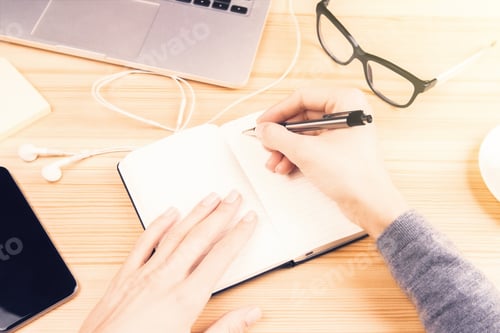 Preview: Girl Writes In Diary And Office Accessories On Wooden Table, Close Up