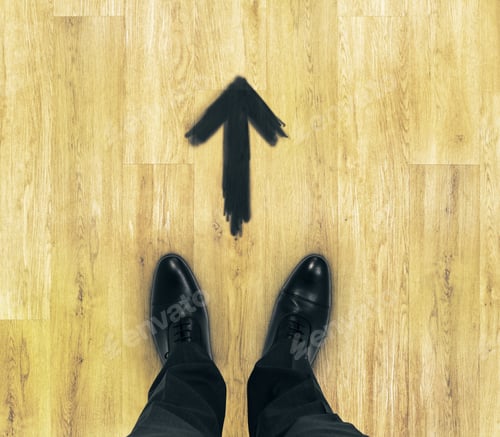 Preview: Top View Of Businessmen Feet On Wooden Floor With Drawn Arrow. Entrepreneurship Concept