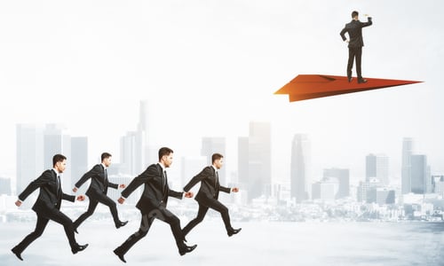 Preview: Row Of Businessmen Following Person On Red Paper Plane On Blurry City Background. Research And