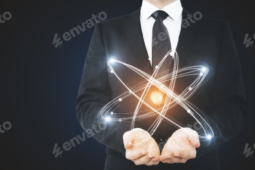 Preview: Unrecognizable Businessman Holding Abstract Glowing Atom. Science Concept