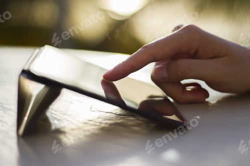 Preview: Man Clicks On A Digital Tablet At Sunset