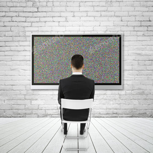 Preview: Businessman Sitting And Looking To Plasma On Brick Wall