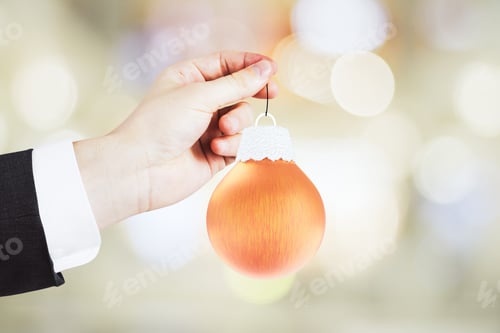 Preview: Man Hand With Christmas Tree Toy - Orange Ball