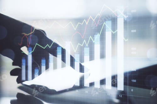Preview: Hand Using Tablet Computer On Desktop With Business Chart Hologram On Blurry Background. Analytics