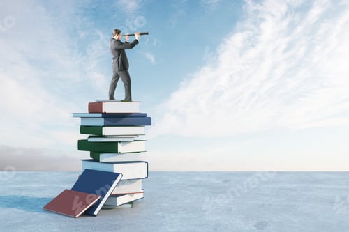 Preview: Businessman With Binoculars Standing On Book Pile. Blue Sky Background. Future And Vision Concept