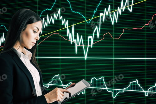 Preview: Attractive Young European Businesswoman Using Tablet With Forex Chart Interface On Blurry