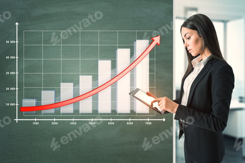 Preview: Attractive Young European Businesswoman With Tablet And Business Chart On Chalkboard. Finance And