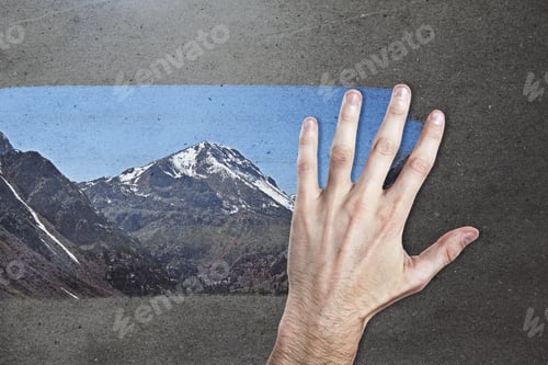 Preview: Male Hand Wiping Concrete Background And Revealing Mountain View. Creativity Concept
