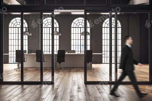 Preview: Businessman Walking In Conference Room In Loft Interior With Panoramic City View And Sunlight