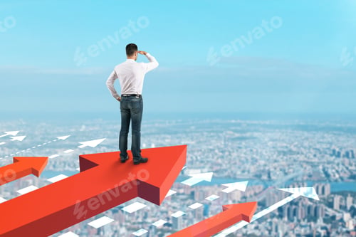 Preview: Businessman Looking Into The Distance On Red Arrows. Blue Sky Background. Growth And Development