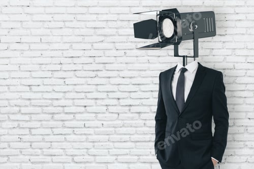 Preview: Spotlight Headed Man Standing On Empty White Brick Wall Background With Copy Space. Professional