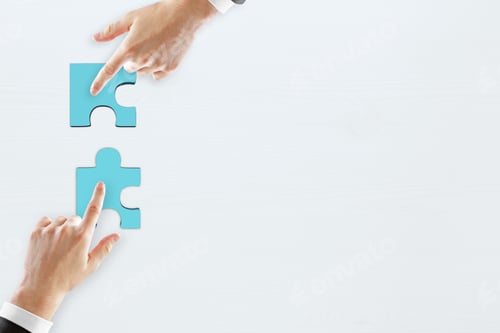Preview: Hands Pointing At Puzzle Pieces On Concrete Background With Copy Space. Teamwork, Communication And
