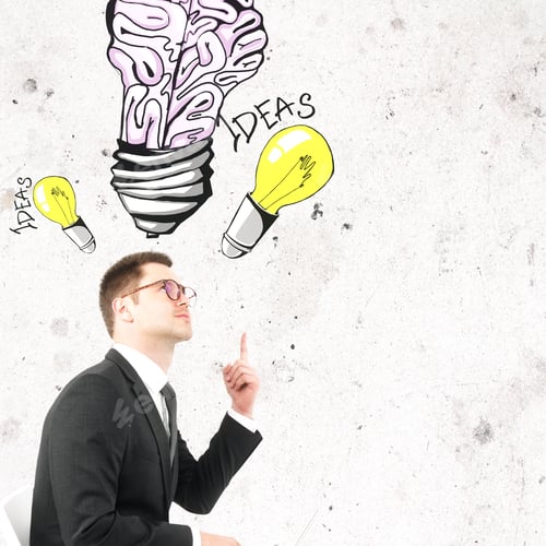 Preview: Handsome Businessman In Glasses Pointing At Creative Light Bulb Brain Sketch. Ideas And