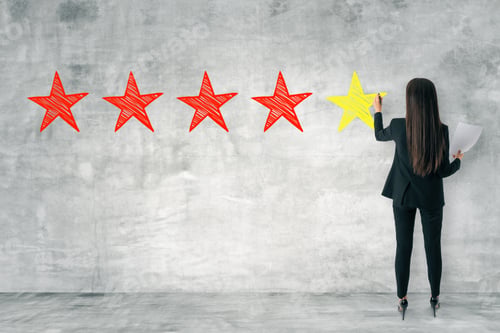 Preview: Back View Of Young Businesswoman Drawing Stars On Concrete Wall. Rating And Exellence Concept
