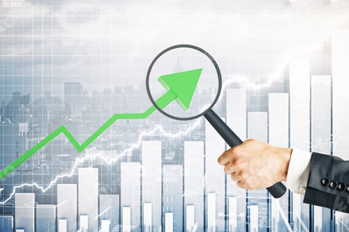 Preview: Hand With Magnifier Over Upward Green Arrow. City With Business Chart Background. Research Concept