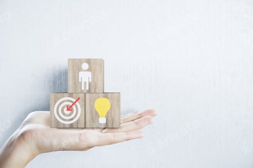 Preview: Hand Holding Business Sign On Wooden Cubes On White Wall Background. Success And Startup Concept.