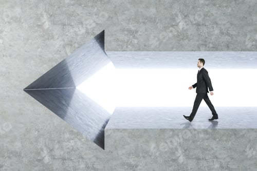 Preview: Side View Of Young Businessman Walking In Arrow Wall. Success And Growth Concept.