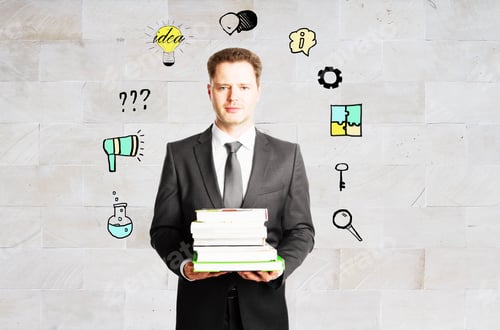 Preview: Handsome Young Businessman With Book Stack And Abstract Business Icons On Concrete Tile Background
