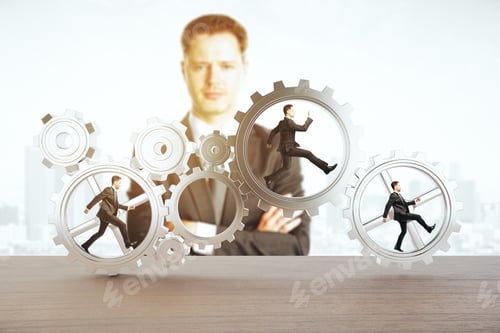 Preview: Man Watching Tiny Businessmen Running Inside Iron Cogwheels. Teamwork And Supervision Concept
