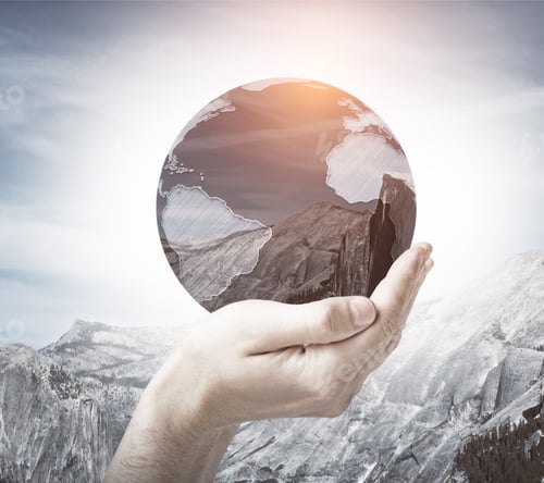 Preview: Male Hand Holding Abstract Globe With Mountains On Sky Background. World Concept. Double Exposure
