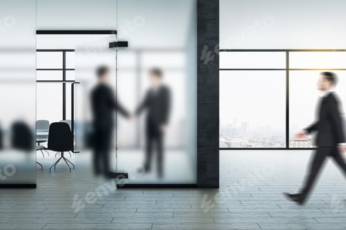 Preview: Thoughtful Young Businesspeople Shaking Hands In Modern Coworking Office Interior With Blurred